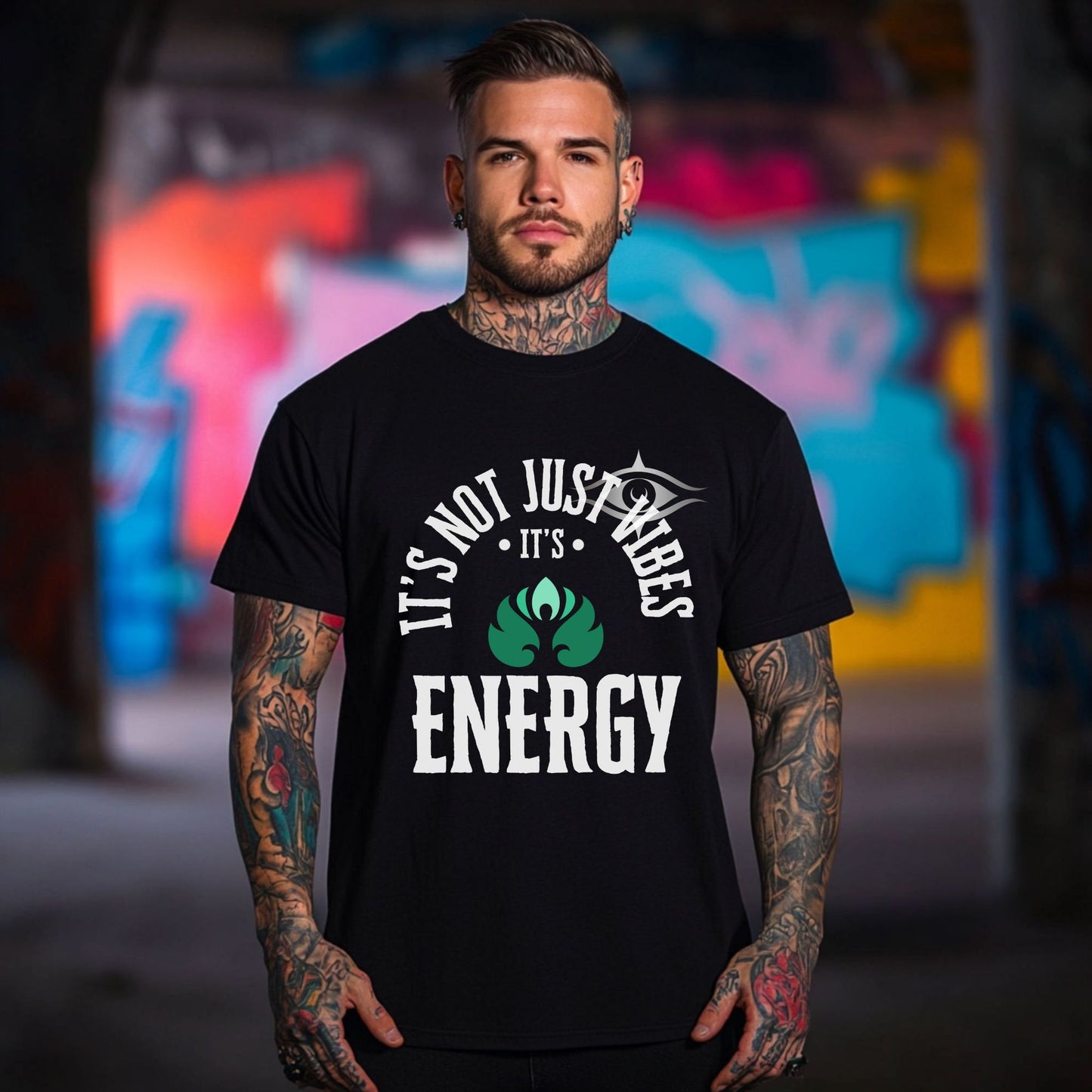 Man wearing a black t-shirt with a graphic design and text, standing in front of a colorful graffiti wall – Lunar Lightwear conscious clothing