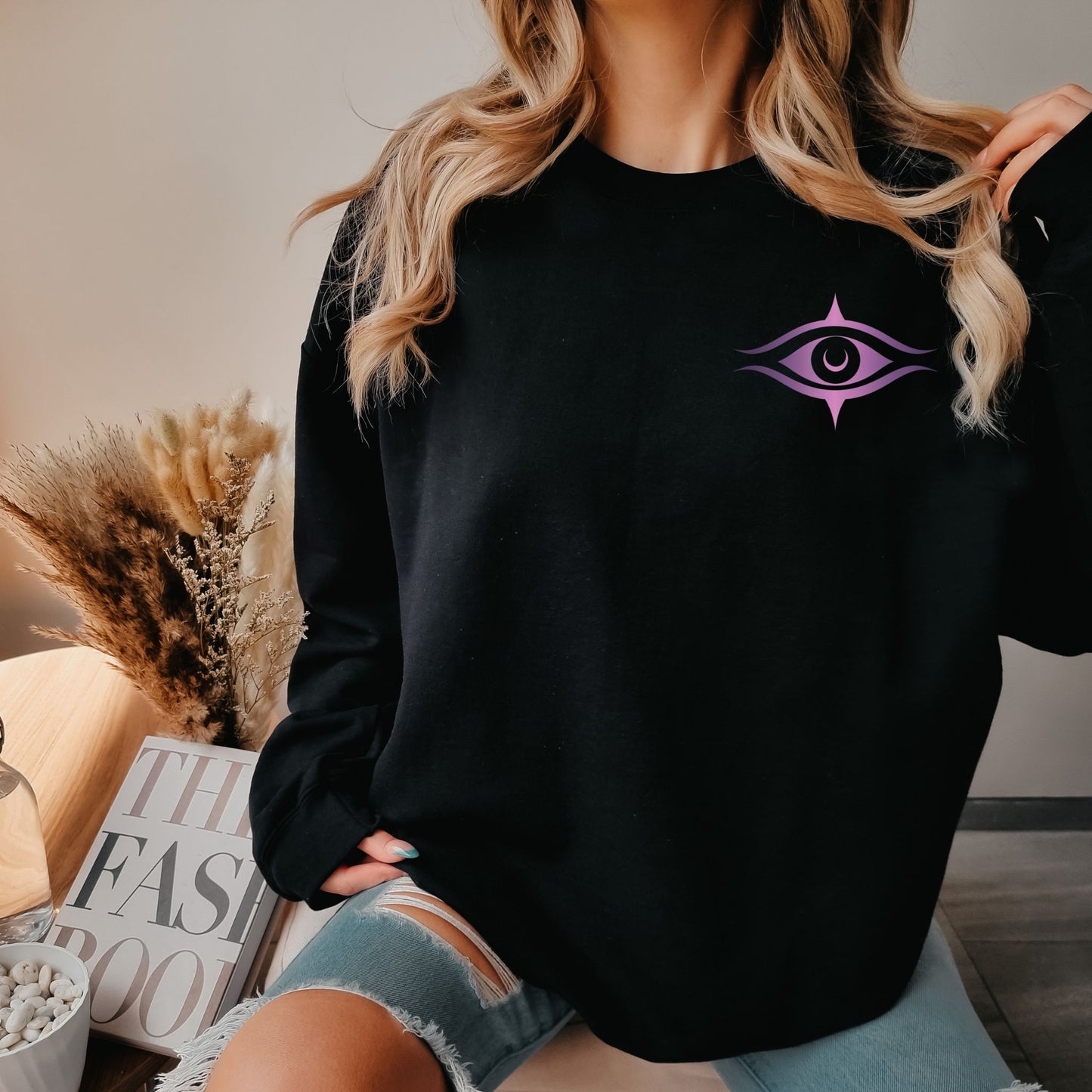 Woman model wearing sweatshirt featuring meditating woman silhouette, cosmic stars, moons, and floral details, a spiritual design – Lunar Lightwear conscious clothing