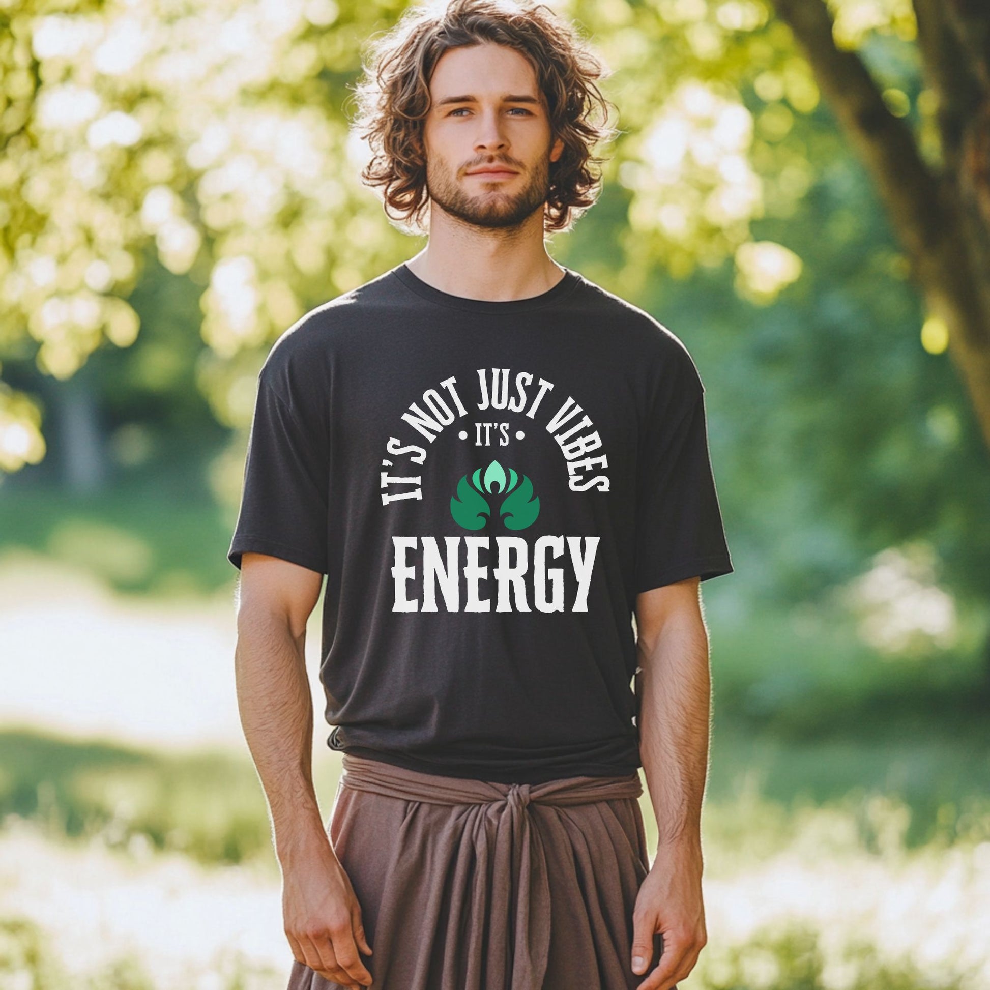 Man wearing a black t-shirt with a motivational quote in a park – Lunar Lightwear conscious clothing