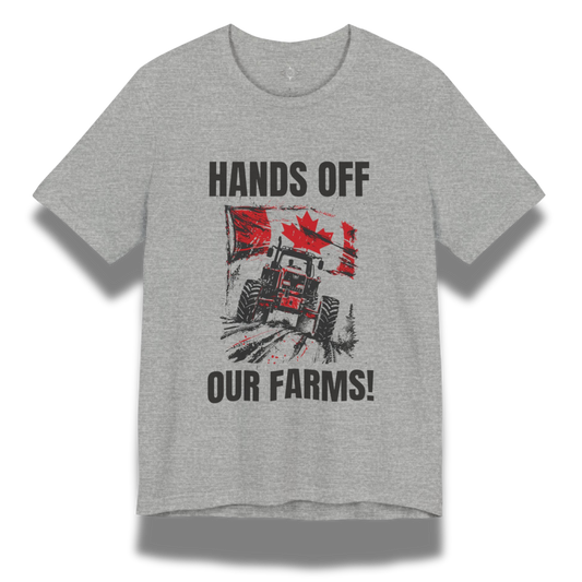 Gray t-shirt with a graphic design featuring a tractor and Canadian flag, text 'HANDS OFF OUR FARMS!', on a white background.