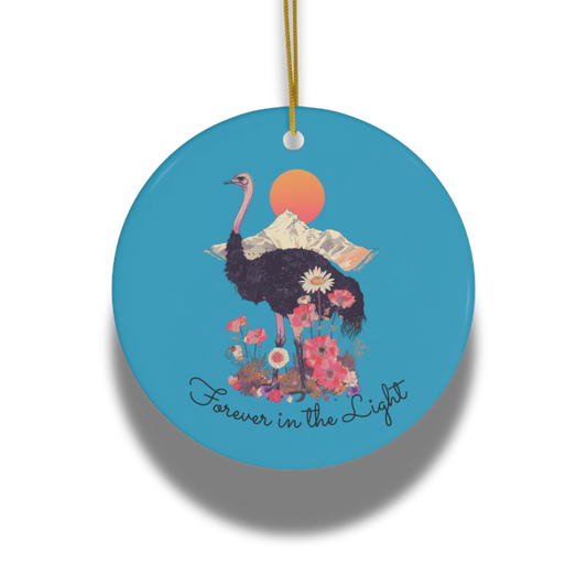 Decorative ornament with an ostrich, flowers, and 'Forever in the Light' text on a blue background.