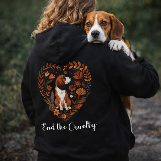 Person wearing a black hoodie with a beagle dog design and 'End the Cruelty' text, standing outdoors.